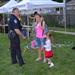 A Villa Park Police Officer stops to talk with a woman at a National Night Out event at the Iowa Community Center, Aug. 2.